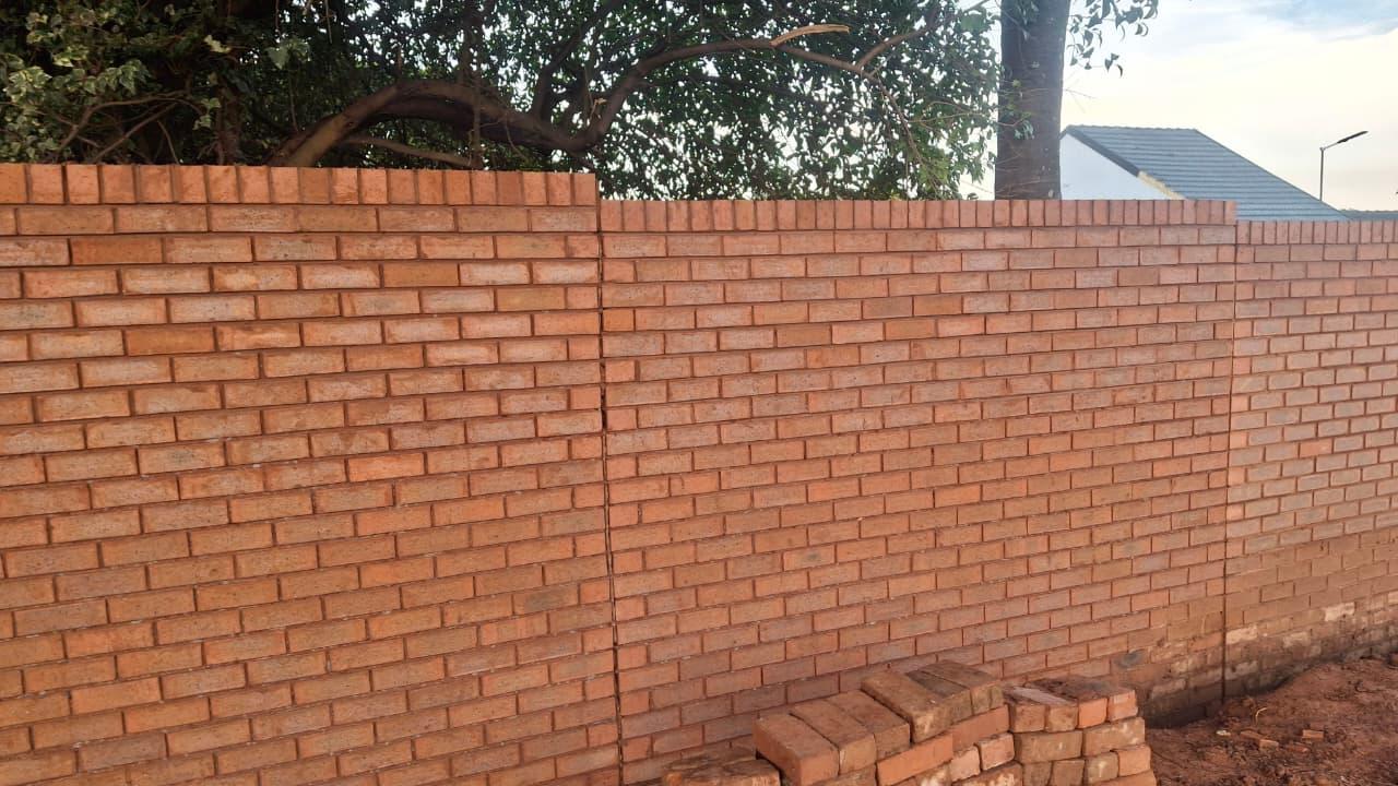 Newly constructed solid red face-brick wall